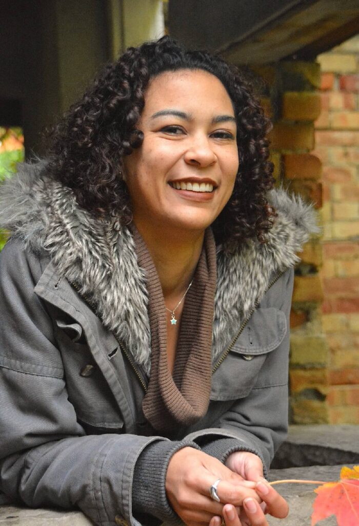 Genevieve Clovis editor and owner of Clovis Editorial. Genevieve smiling at the camera.