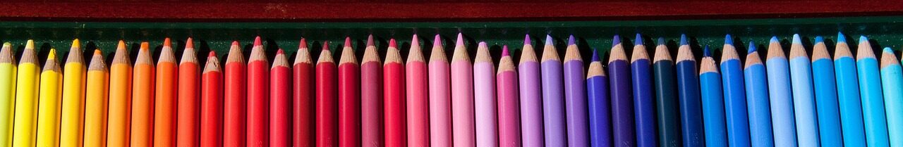 coloured pencils lined up in a rainbow